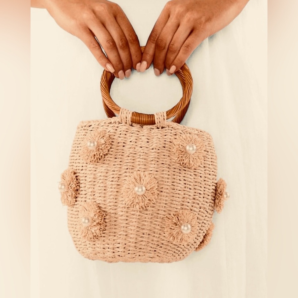 Woven straw bag w/ fringe flowers & faux-pearls Ring handles drawstring closure